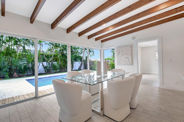 dining area featuring lofted ceiling with beams and light wood-type flooring