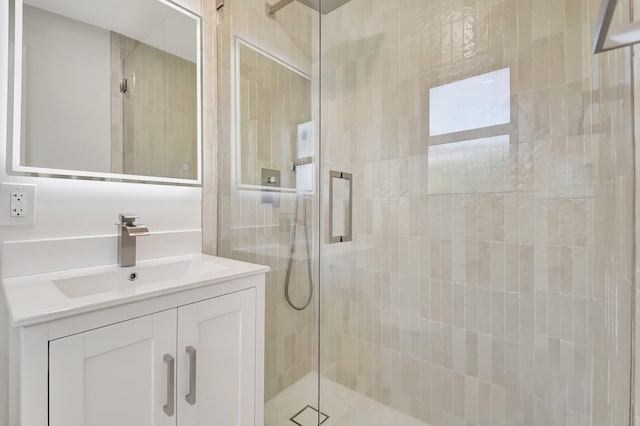 bathroom featuring vanity and an enclosed shower