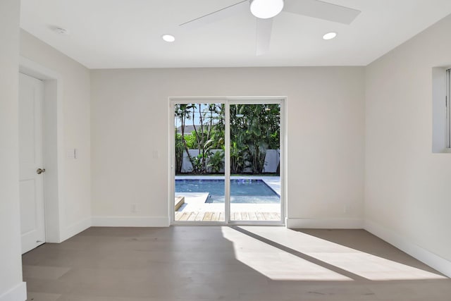 spare room with ceiling fan and wood-type flooring