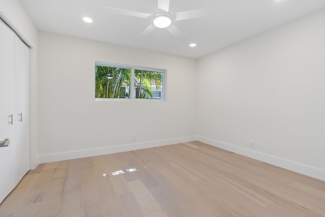 unfurnished bedroom with ceiling fan and light wood-type flooring