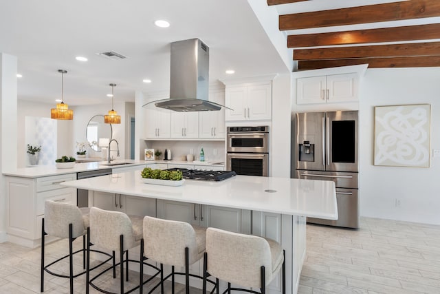 kitchen featuring sink, white cabinetry, island range hood, a kitchen island, and stainless steel appliances