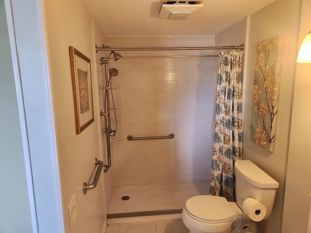 bathroom with toilet, tile patterned floors, and a shower with curtain