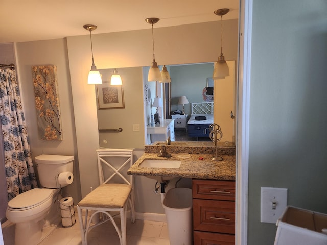 bathroom with toilet, tile patterned flooring, and sink