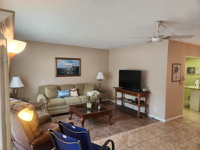 tiled living room with ceiling fan and a textured ceiling