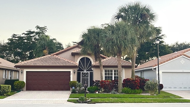 mediterranean / spanish house with a garage