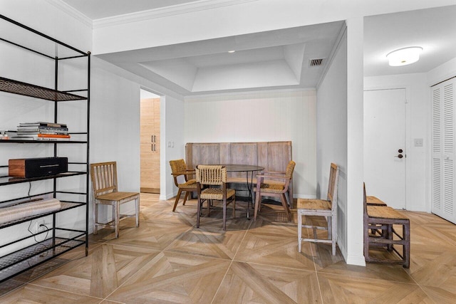 dining room featuring crown molding and light parquet flooring