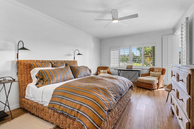 bedroom featuring wood-type flooring, ceiling fan, and crown molding