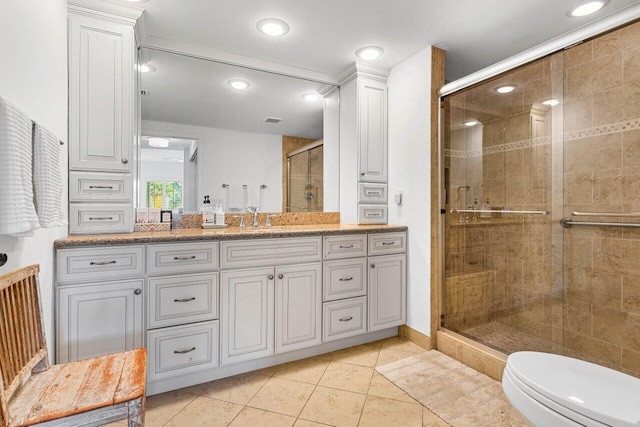 bathroom with vanity, toilet, tile patterned floors, and walk in shower