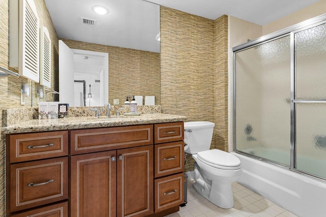 full bathroom with vanity, tile patterned flooring, enclosed tub / shower combo, and toilet