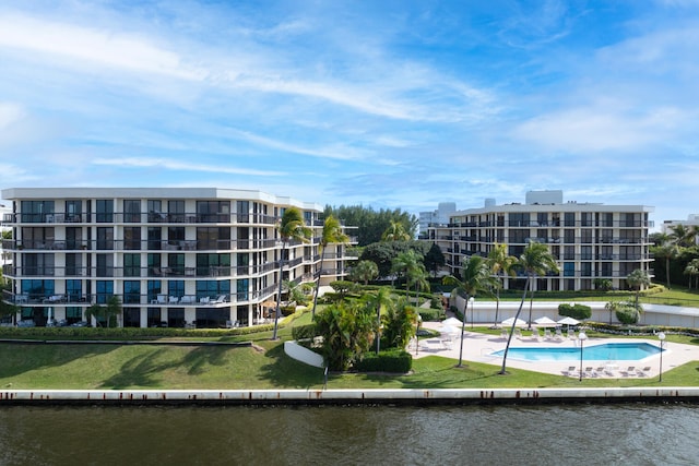 exterior space featuring a water view and a community pool