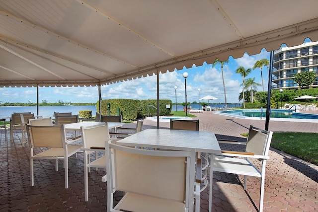 view of patio / terrace with a water view and a community pool