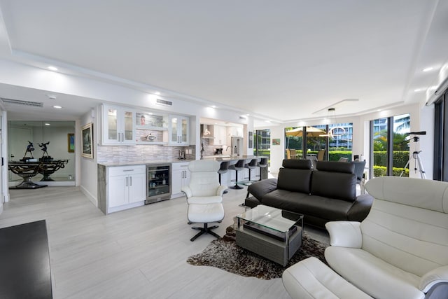 living room featuring wine cooler and bar