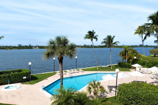 view of pool featuring a patio and a water view