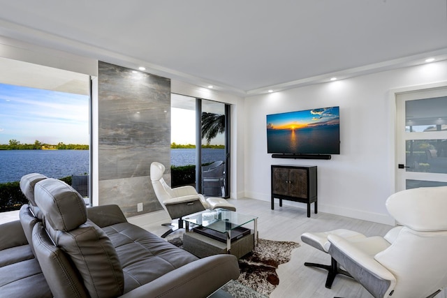 living room with a water view and light wood-type flooring