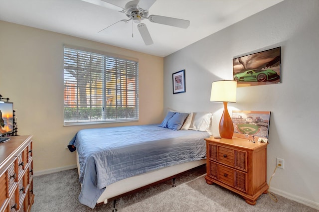 bedroom with ceiling fan and light carpet