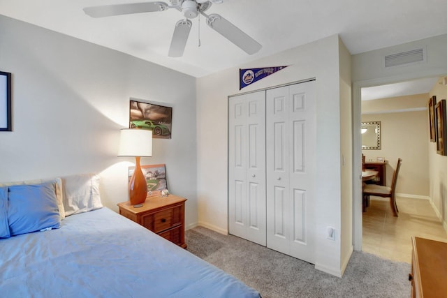 carpeted bedroom featuring a closet and ceiling fan