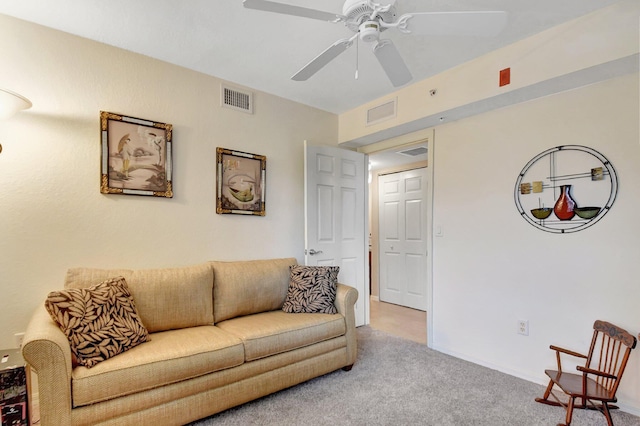 living room featuring light carpet and ceiling fan