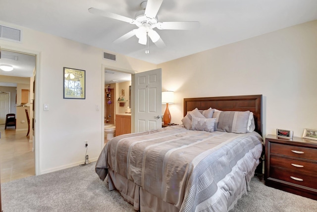 carpeted bedroom with ceiling fan and ensuite bathroom