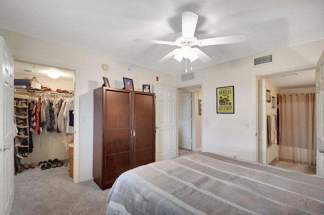 carpeted bedroom featuring ceiling fan and a closet