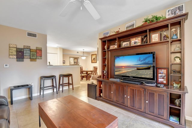 living room featuring light tile patterned floors and ceiling fan