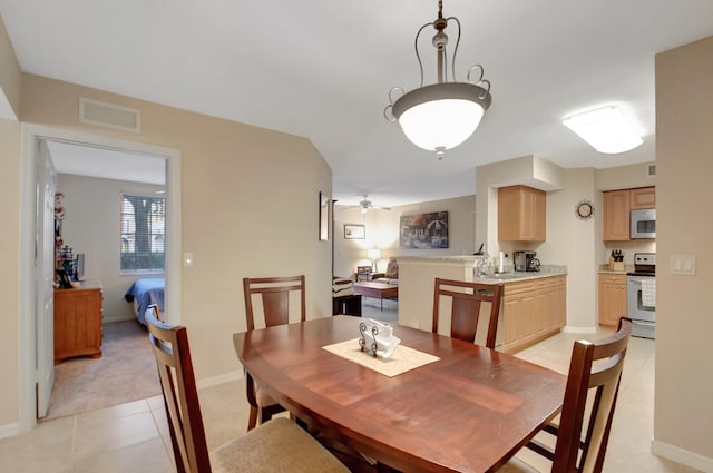 tiled dining room featuring ceiling fan