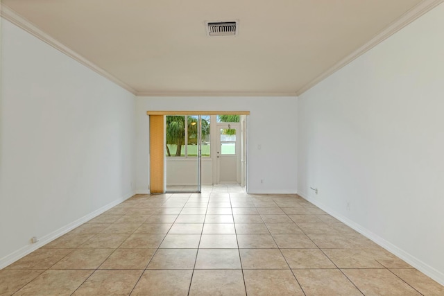 empty room with light tile patterned flooring and ornamental molding