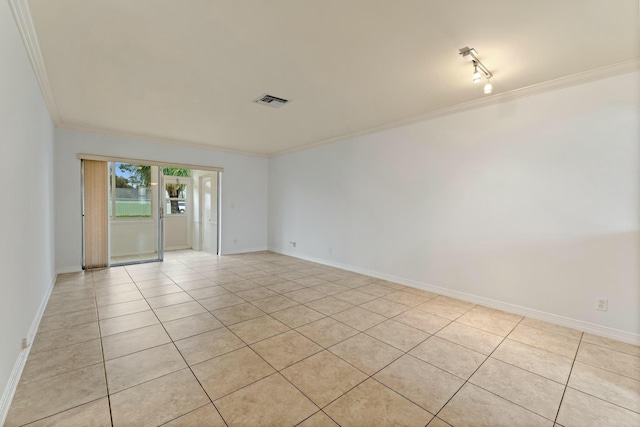 unfurnished room featuring light tile patterned flooring, crown molding, and rail lighting