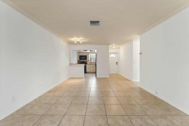 interior space with light tile patterned floors and ornamental molding