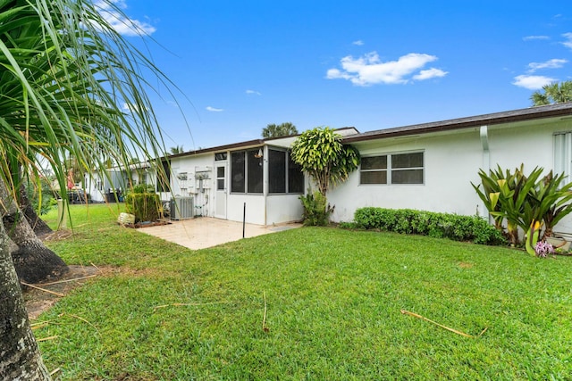 back of property featuring a yard, central air condition unit, and a patio area