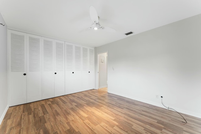 unfurnished bedroom with light wood-type flooring and ceiling fan