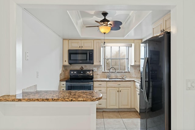 kitchen featuring range with electric stovetop, sink, kitchen peninsula, a raised ceiling, and black fridge