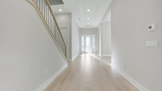 corridor featuring french doors and light hardwood / wood-style floors