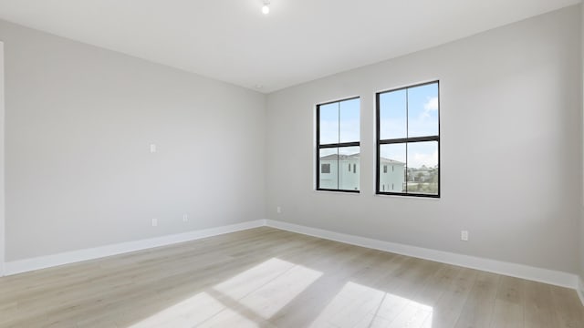 unfurnished room with light hardwood / wood-style floors