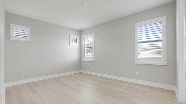 unfurnished room with light wood-type flooring