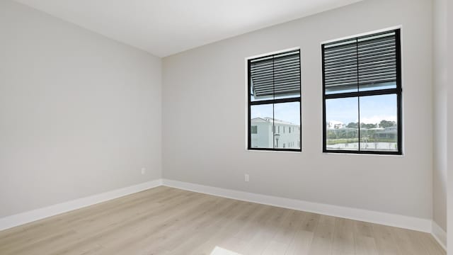 spare room featuring light hardwood / wood-style floors