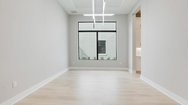 spare room with light hardwood / wood-style flooring