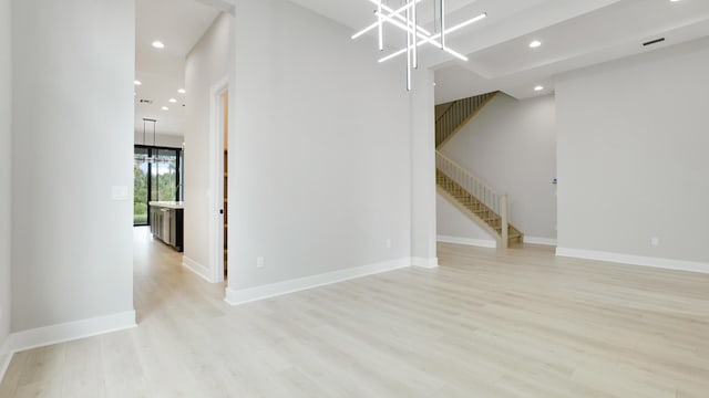 interior space featuring a chandelier and light wood-type flooring