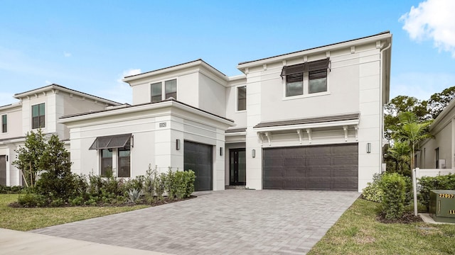 view of front of property featuring a garage and a front yard