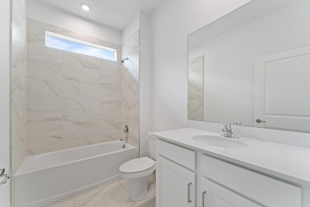 full bathroom with vanity, tiled shower / bath combo, and toilet