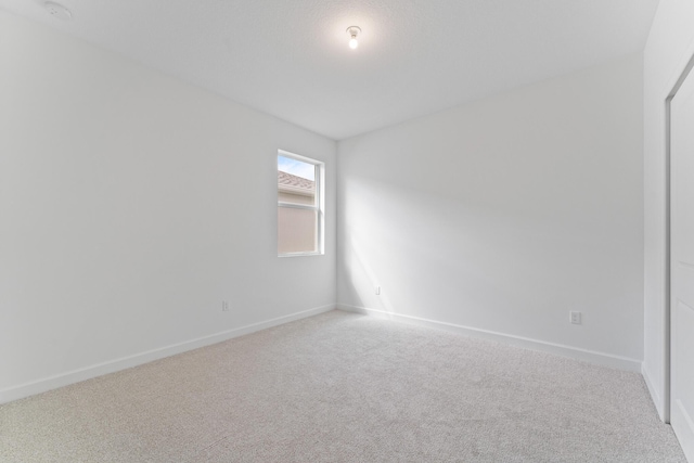 empty room with light colored carpet