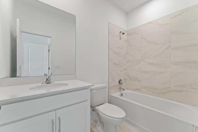 full bathroom with tiled shower / bath, vanity, and toilet