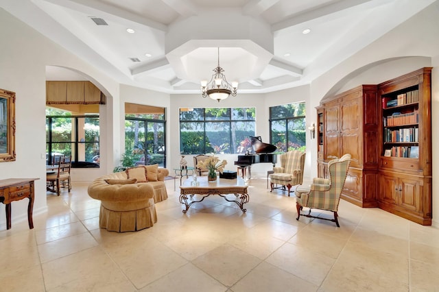 living area with beam ceiling, plenty of natural light, coffered ceiling, and a chandelier