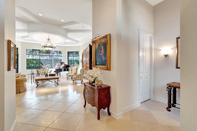 hall featuring a notable chandelier and light tile patterned floors