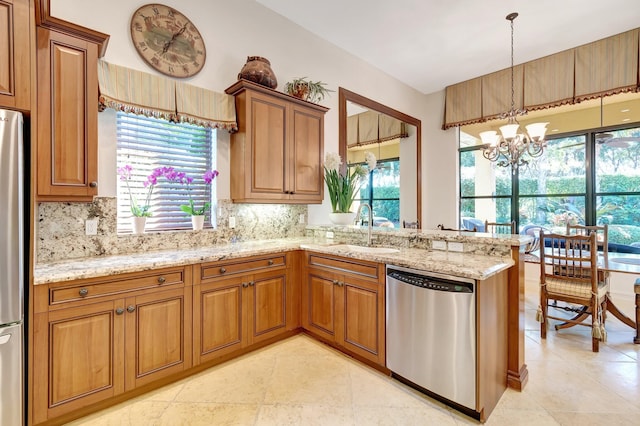 kitchen with appliances with stainless steel finishes, sink, decorative backsplash, a notable chandelier, and kitchen peninsula