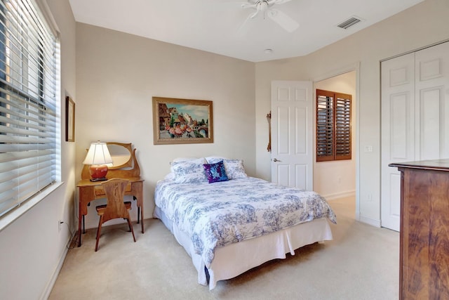 bedroom with light carpet and ceiling fan