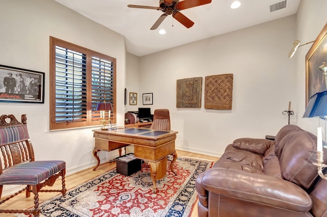 home office featuring hardwood / wood-style flooring and ceiling fan