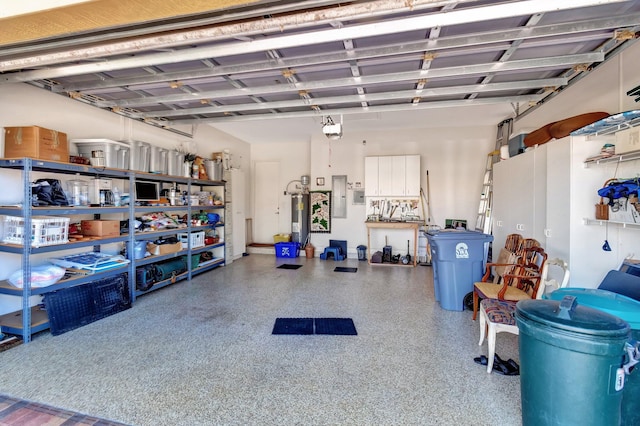 garage featuring a garage door opener, electric panel, and water heater