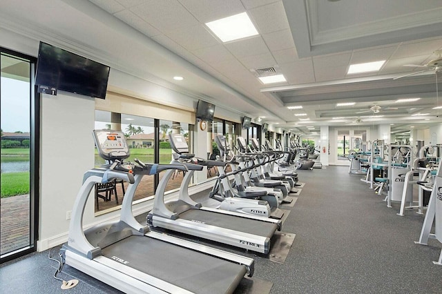 workout area featuring visible vents, a paneled ceiling, baseboards, and ceiling fan