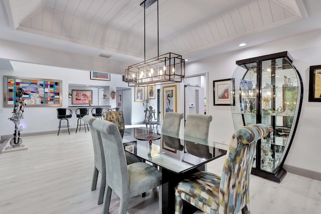 dining room with wood ceiling and light hardwood / wood-style floors