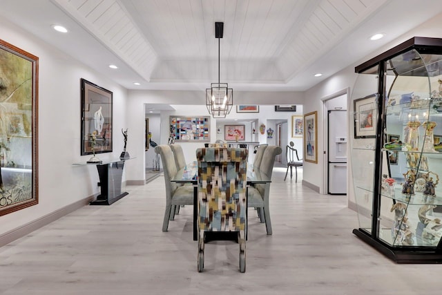 dining room featuring wood ceiling, a chandelier, a raised ceiling, and light hardwood / wood-style floors